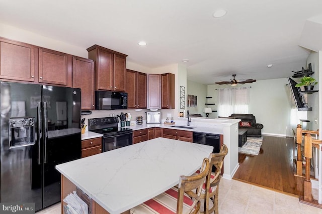 - kitchen with black appliances, a peninsula, open floor plan, a ceiling fan, and recessed lighting