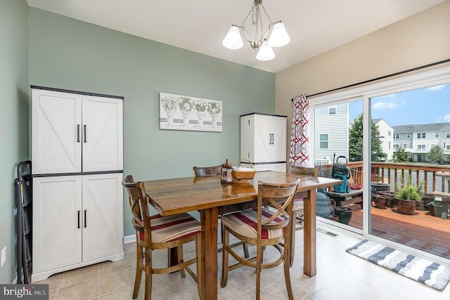  - dining area featuring a chandelier
