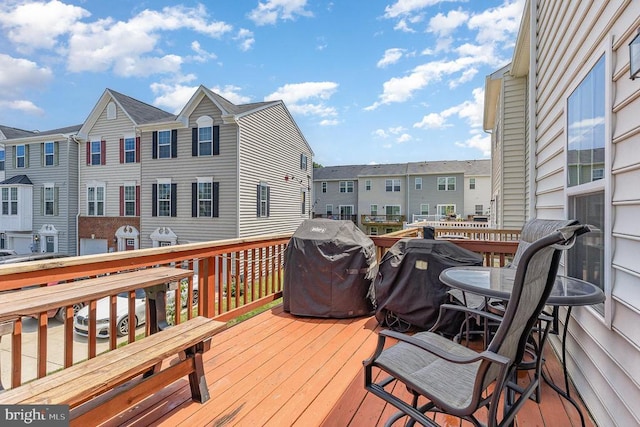  - wooden deck with a grill and a residential view