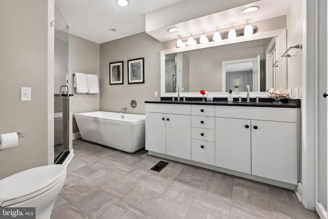 325 Oneals Rd, Madison, VA 22727 - bathroom featuring double vanity, a stall shower, a soaking tub, toilet, and recessed lighting