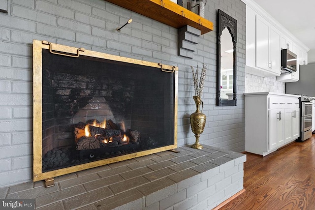 325 Oneals Rd, Madison, VA 22727 - detailed view of wood finished floors, appliances with stainless steel finishes, and a fireplace