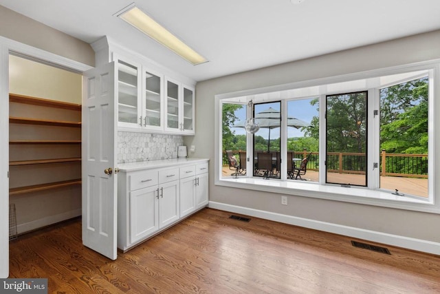 325 Oneals Rd, Madison, VA 22727 - bar area with baseboards, wood finished floors, and tasteful backsplash