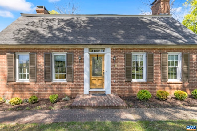 330 Carrsbrook Dr, Charlottesville, VA 22901 - view of front facade with a chimney, brick siding, and roof with shingles