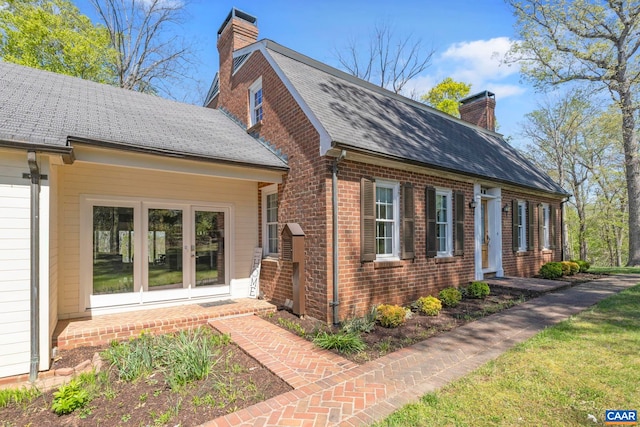 330 Carrsbrook Dr, Charlottesville, VA 22901 - view of home's exterior with a chimney, french doors, brick siding, and a shingled roof