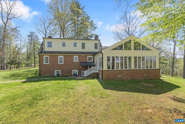 330 Carrsbrook Dr, Charlottesville, VA 22901 - back of property with a yard, a chimney, brick siding, and a sunroom