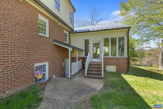 330 Carrsbrook Dr, Charlottesville, VA 22901 - doorway to property featuring a standing seam roof, brick siding, a lawn, and metal roof