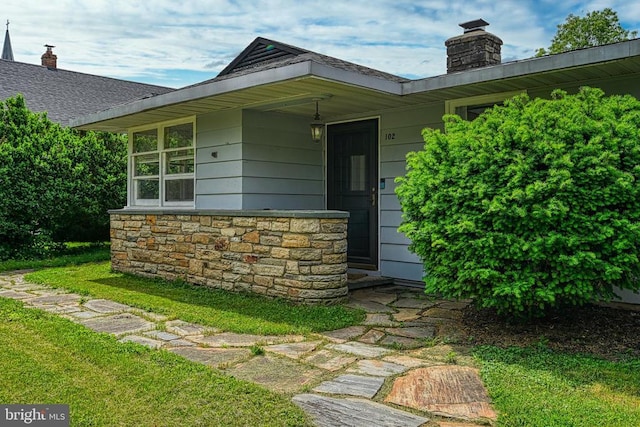 102 Washington St E, Remington, VA 22734 - doorway to property with a chimney, a lawn, and stone siding