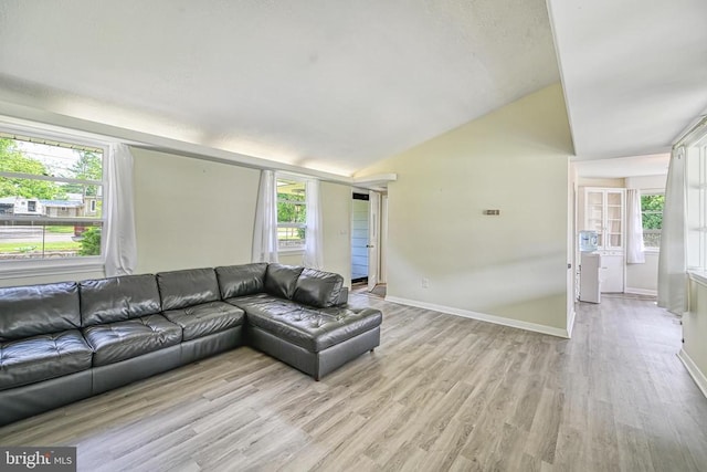 102 Washington St E, Remington, VA 22734 - living room featuring light wood-style floors, vaulted ceiling, plenty of natural light, and baseboards