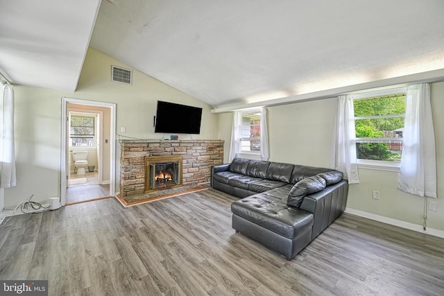 102 Washington St E, Remington, VA 22734 - living room featuring vaulted ceiling, wood finished floors, a fireplace, and baseboards