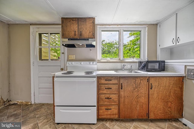 102 Washington St E, Remington, VA 22734 - kitchen with exhaust hood, white electric stove, a sink, light countertops, and brown cabinets