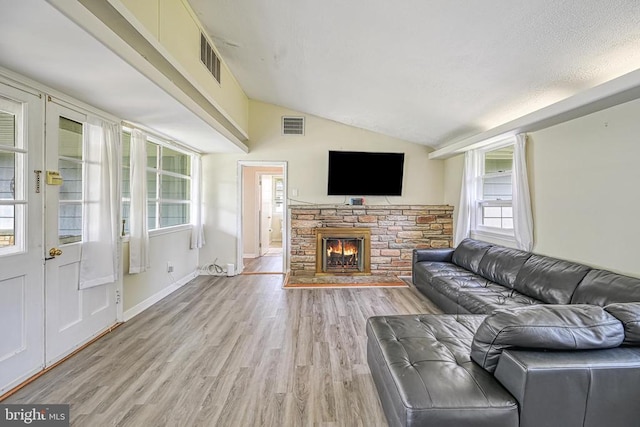 102 Washington St E, Remington, VA 22734 - living area with vaulted ceiling, light wood-style flooring, a fireplace, and baseboards