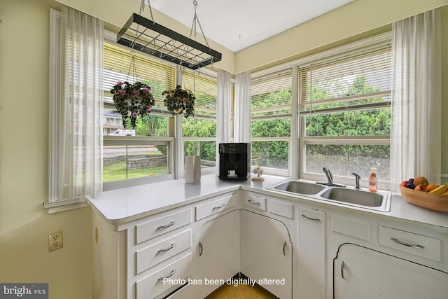 102 Washington St E, Remington, VA 22734 - kitchen with light countertops, plenty of natural light, white cabinets, and a sink