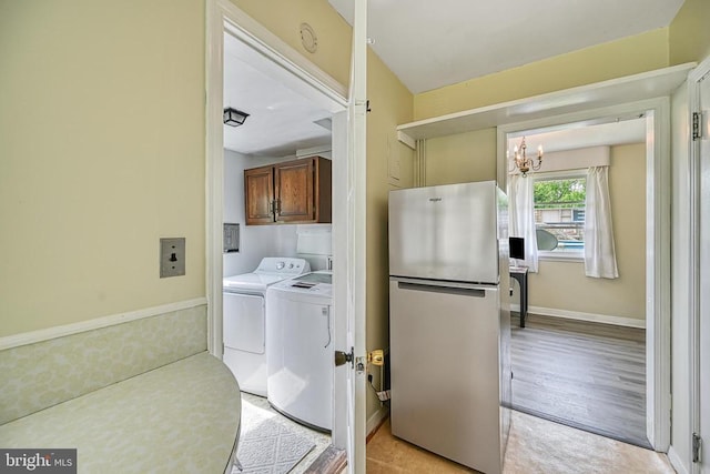 102 Washington St E, Remington, VA 22734 - washroom featuring cabinet space, a chandelier, washer and dryer, and light wood finished floors