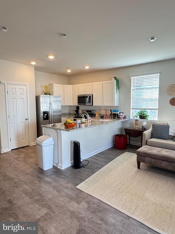 182 Allison Dr, Luray, VA 22835 - kitchen featuring stainless steel appliances, white cabinetry, a peninsula, recessed lighting, and light stone countertops