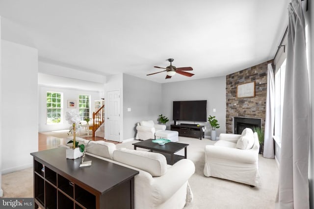9016 Laurel Oak Ln, Fredericksburg, VA 22407 - carpeted living room featuring ceiling fan, a fireplace, and stairs