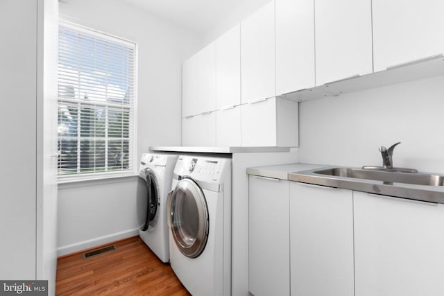 9016 Laurel Oak Ln, Fredericksburg, VA 22407 - laundry room with cabinet space, independent washer and dryer, plenty of natural light, and wood finished floors