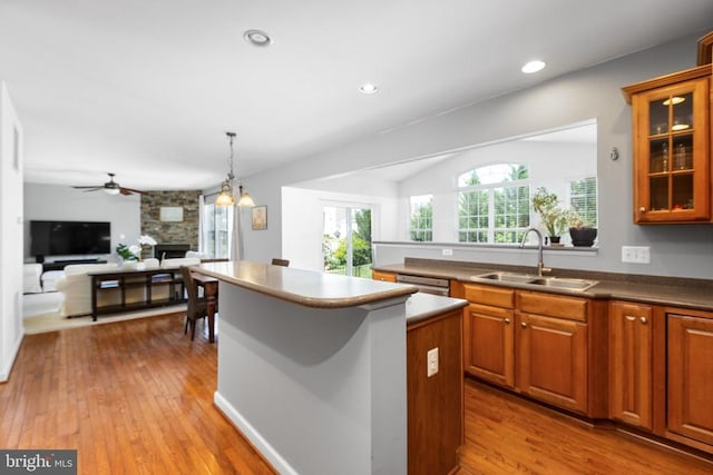 9016 Laurel Oak Ln, Fredericksburg, VA 22407 - kitchen featuring a sink, hardwood / wood-style floors, a center island, a fireplace, and glass insert cabinets