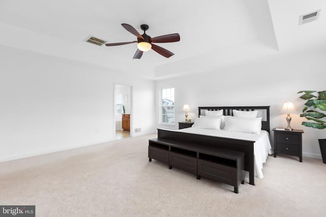 9016 Laurel Oak Ln, Fredericksburg, VA 22407 - bedroom with carpet, a tray ceiling, a ceiling fan, and connected bathroom