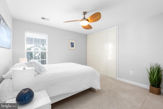 9016 Laurel Oak Ln, Fredericksburg, VA 22407 - bedroom with a closet, light colored carpet, ceiling fan, and baseboards
