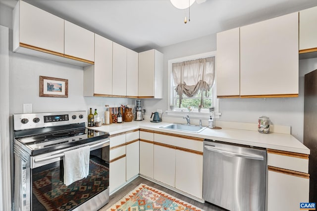 1605 Oakleaf Ln, Charlottesville, VA 22903 - kitchen with appliances with stainless steel finishes, light countertops, light wood-style flooring, and white cabinetry