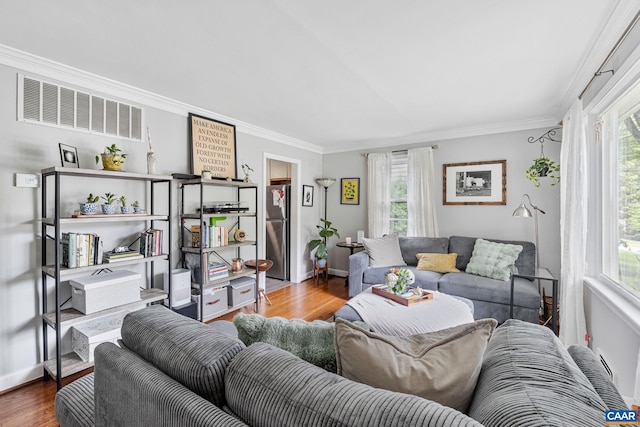 1605 Oakleaf Ln, Charlottesville, VA 22903 - living area with wood finished floors, healthy amount of natural light, and ornamental molding