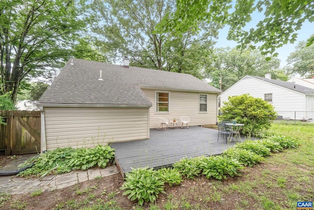 1605 Oakleaf Ln, Charlottesville, VA 22903 - back of property featuring a wooden deck, a shingled roof, and outdoor dining space