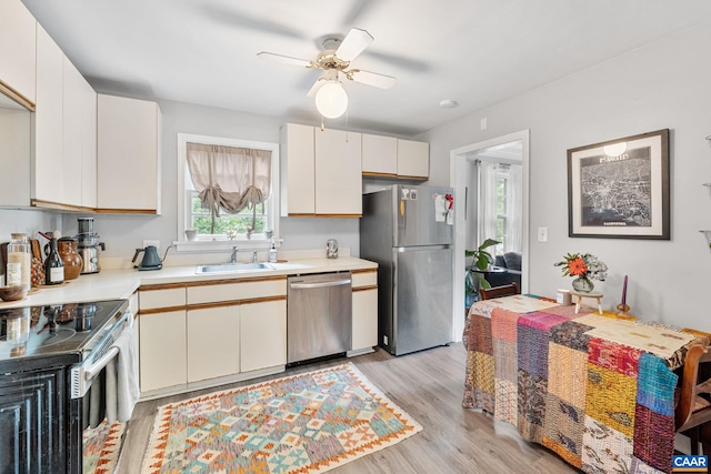 1605 Oakleaf Ln, Charlottesville, VA 22903 - kitchen featuring stainless steel appliances, light wood finished floors, light countertops, and a ceiling fan