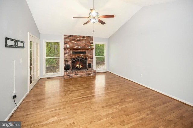 unfurnished living room featuring ceiling fan, plenty of natural light, and vaulted ceiling