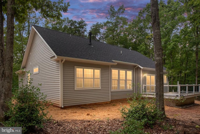 79 Hickory Cir, Mineral, VA 23117 - back of property at dusk with a deck and roof with shingles