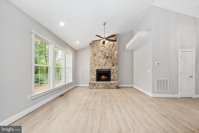 79 Hickory Cir, Mineral, VA 23117 - unfurnished living room featuring ceiling fan, wood finished floors, vaulted ceiling, and a stone fireplace