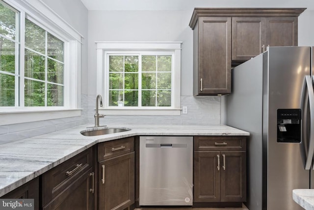 79 Hickory Cir, Mineral, VA 23117 - kitchen featuring appliances with stainless steel finishes, backsplash, dark brown cabinets, and light stone counters