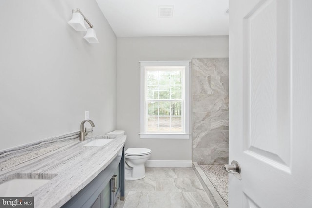 79 Hickory Cir, Mineral, VA 23117 - bathroom featuring tiled shower, double vanity, and marble look tile flooring