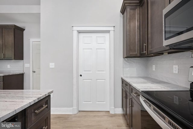 79 Hickory Cir, Mineral, VA 23117 - kitchen with appliances with stainless steel finishes, dark brown cabinets, light wood-style floors, and light stone countertops