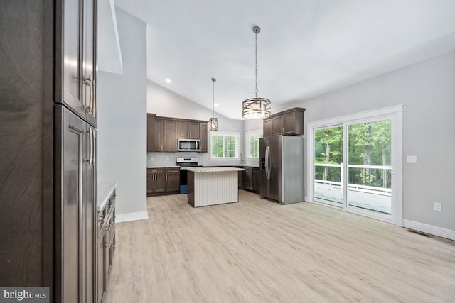 79 Hickory Cir, Mineral, VA 23117 - kitchen featuring stainless steel appliances, dark brown cabinetry, light wood-style flooring, vaulted ceiling, and light countertops
