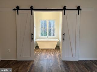 Old Lawyers Rd, Unionville, VA 22567 - bathroom with wood finished floors, baseboards, and a freestanding tub