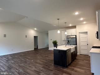 Old Lawyers Rd, Unionville, VA 22567 - kitchen featuring stainless steel fridge, light countertops, hanging light fixtures, dark wood-type flooring, and a kitchen island with sink