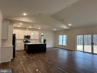 Old Lawyers Rd, Unionville, VA 22567 - kitchen with stainless steel microwave, freestanding refrigerator, lofted ceiling, open floor plan, and dark wood-style flooring