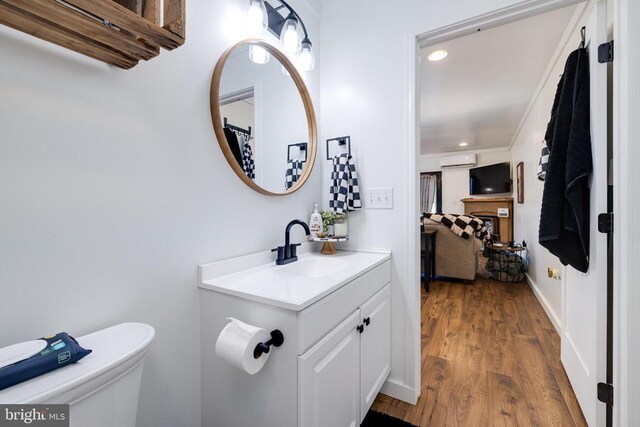 1246 Whispering Hill Rd, Luray, VA 22835 - bathroom featuring a wall mounted air conditioner, vanity, recessed lighting, wood finished floors, and toilet