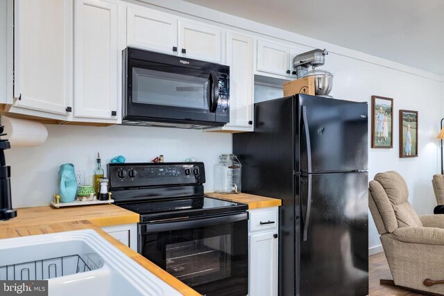 1246 Whispering Hill Rd, Luray, VA 22835 - kitchen with wood counters, black appliances, white cabinets, and wood finished floors