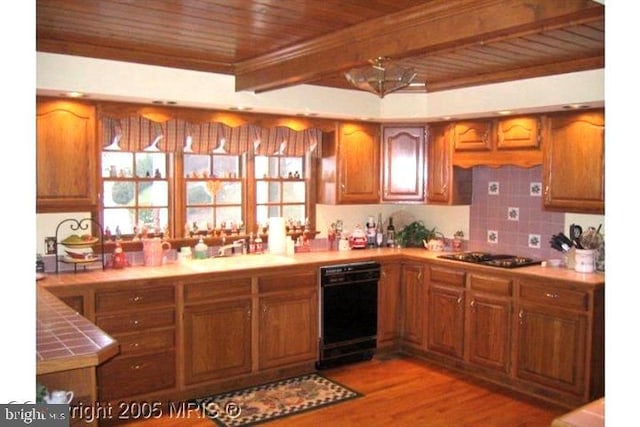 8408 Hildy Ct W, Spotsylvania, VA 22553 - kitchen with black dishwasher, gas stovetop, wood ceiling, tile counters, and brown cabinetry