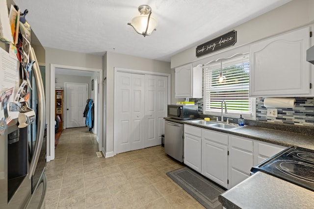 701 Horseshoe Cir, Stuarts Draft, VA 24477 - kitchen featuring a sink, stainless steel appliances, white cabinetry, and tasteful backsplash
