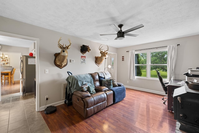 701 Horseshoe Cir, Stuarts Draft, VA 24477 - living area with ceiling fan, baseboards, wood finished floors, a chandelier, and a textured ceiling