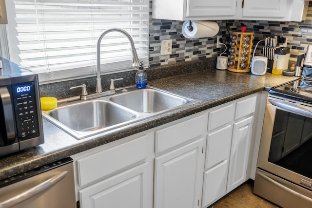 701 Horseshoe Cir, Stuarts Draft, VA 24477 - kitchen featuring appliances with stainless steel finishes, a sink, white cabinetry, backsplash, and dark countertops