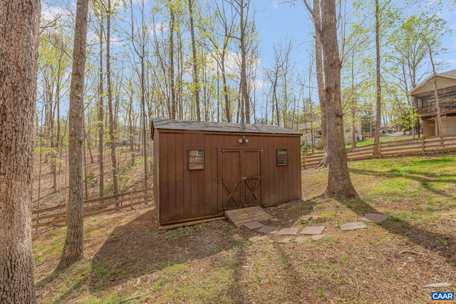 view of shed with fence
