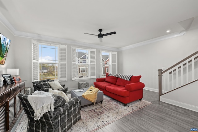 living area with ornamental molding, wood finished floors, ceiling fan, baseboards, and recessed lighting