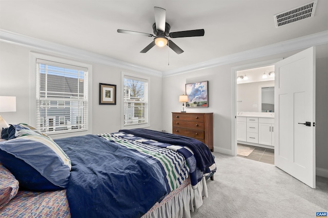 bedroom featuring light colored carpet, ornamental molding, baseboards, connected bathroom, and ceiling fan