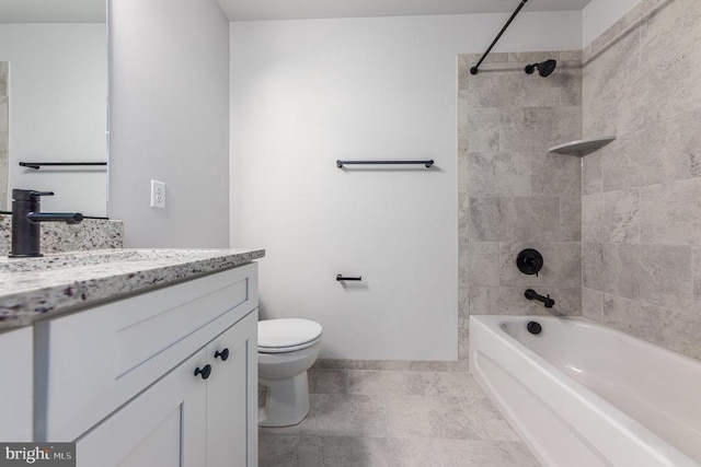bathroom featuring vanity, toilet, shower / washtub combination, and baseboards