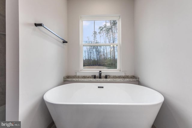 full bathroom featuring a soaking tub