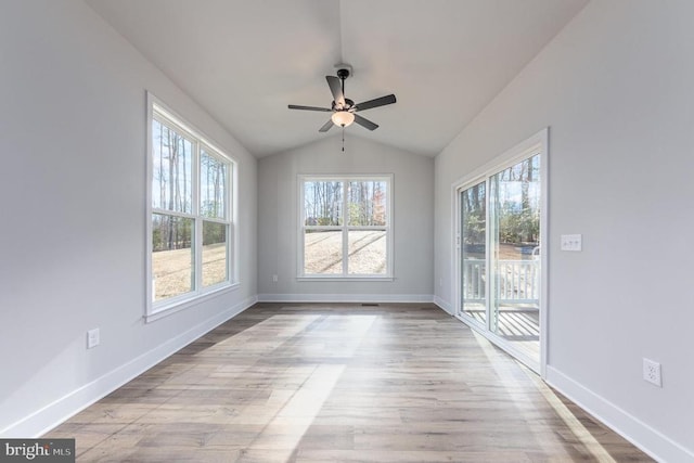 unfurnished room featuring lofted ceiling, baseboards, ceiling fan, and wood finished floors