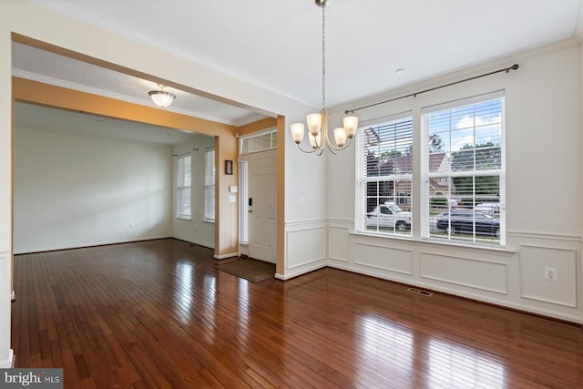 5505 Spring Bluff Ct, Fredericksburg, VA 22407 - unfurnished dining area featuring a chandelier, hardwood / wood-style floors, a wainscoted wall, ornamental molding, and a decorative wall